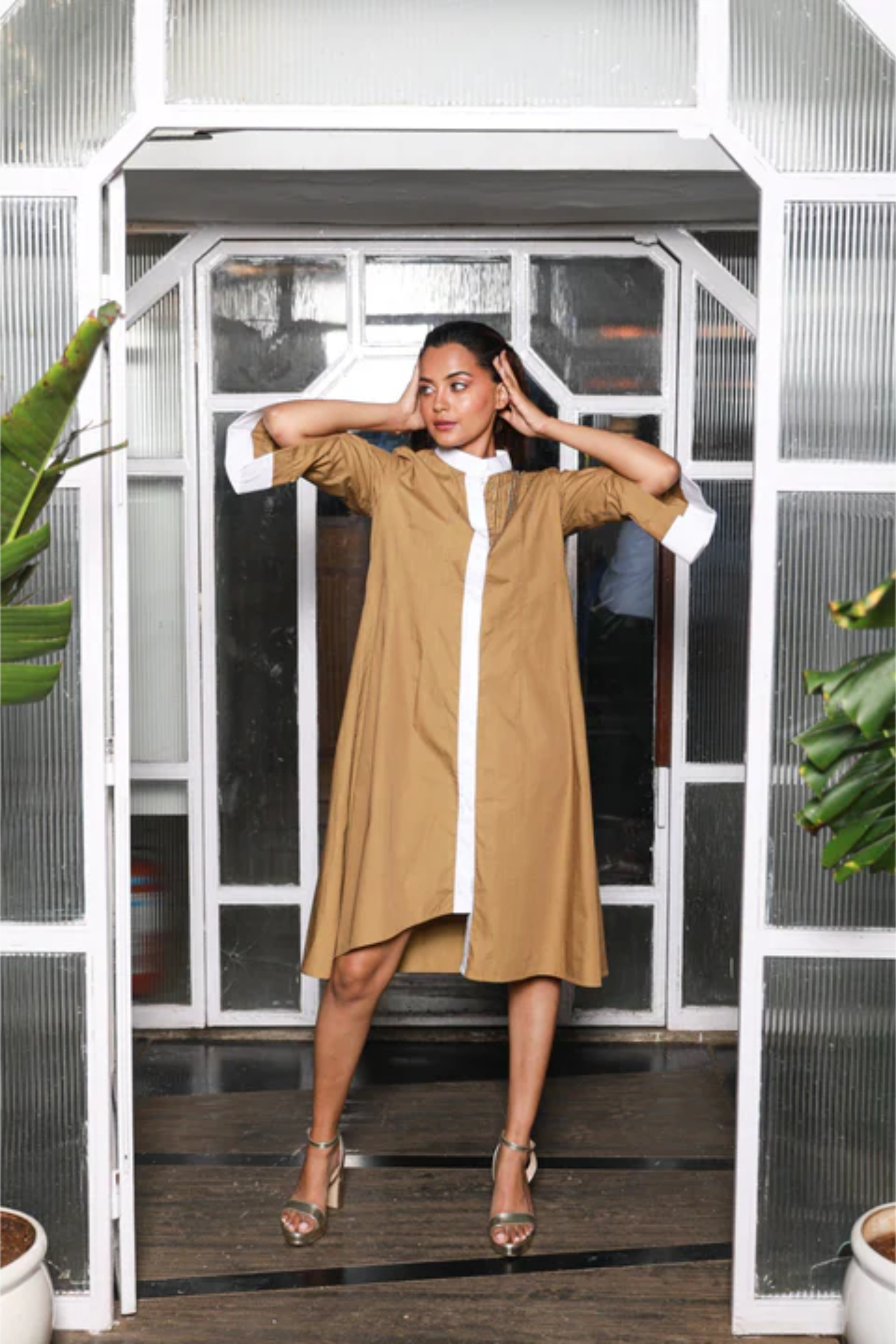 Khaki shirt dress features white mandarin collar, white cuffs and chain feature on the shoulder.